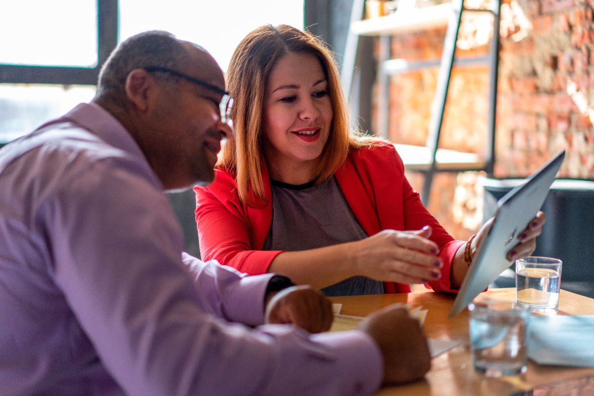 An advisor and an investor reviewing plans together at a table
